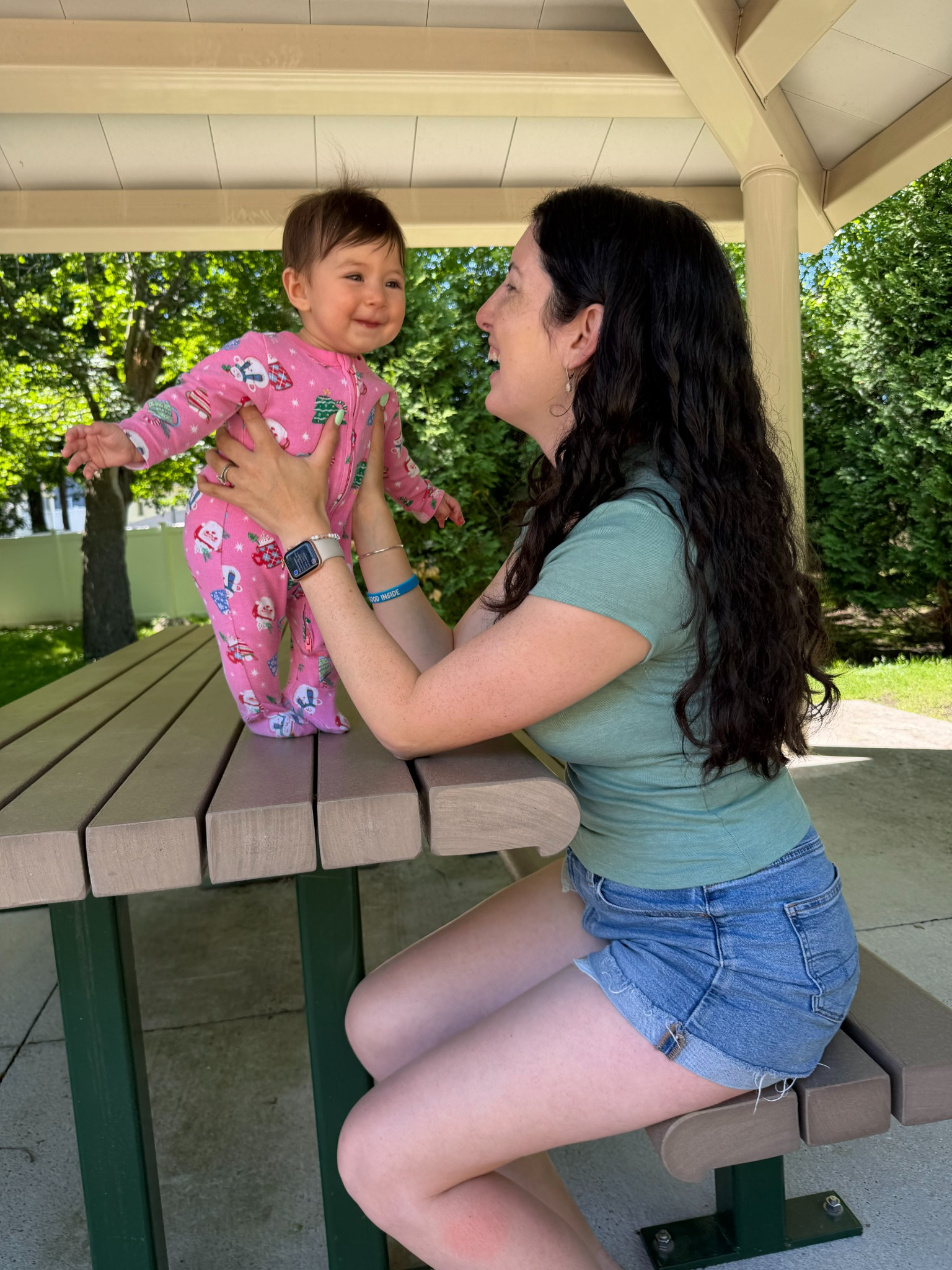 Bethany playing with her baby outdoors